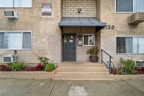 North Hollywood apartment for rent - The front of apartment number 730 with a blue door and steps leading up to it.