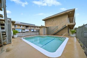 North Hollywood apartment for rent - A small pool in a backyard with a staircase leading to a balcony.