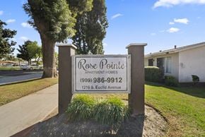 Ontario apartment for rent - A sign for Rose Pointe Apartment Homes stands in front of a tree.
