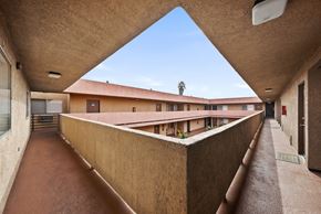 Long Beach apartment for rent - A long hallway with a roof that is sloped in the middle.