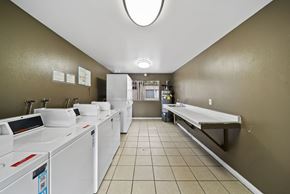 Long Beach apartment for rent - A laundromat with washers and dryers lined up on both sides of the room.