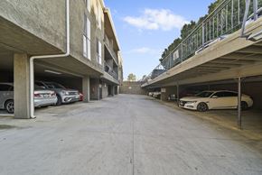 North Hills apartment for rent - A parking garage with cars parked on both sides.