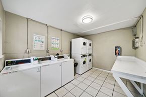 Whittier apartment for rent - A clean, white-walled room with a white table and a white oven.