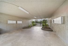 Whittier apartment for rent - A concrete room with a planter and two white boards on the wall.