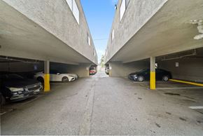 Whittier apartment for rent - A parking garage with cars parked on both sides of the aisle.