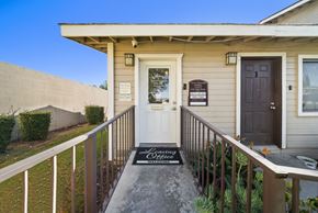 Fontana apartment for rent - A house with a white door and a sign that says "Loving Wife".