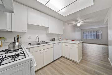 Perris apartment for rent - A white kitchen with a stove and sink.