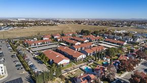 Palmdale apartment for rent - A bird's eye view of a residential area with houses and parked cars.
