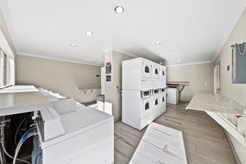 Palmdale apartment for rent - A kitchen with white appliances and wooden flooring.
