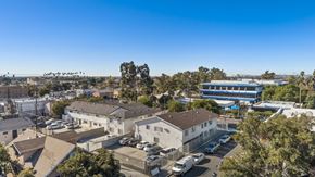 Los Angeles apartment for rent - A clear blue sky over a residential area with houses and parked cars.