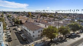 Los Angeles apartment for rent - A street view of a residential area with houses and parked cars.