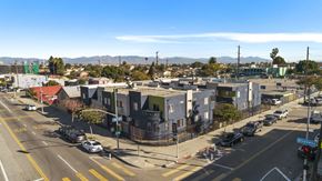 Los Angeles apartment for rent - A street view of a residential area with houses and cars.