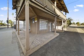 Santa Ana apartment for rent - A wooden building with a porch and a covered walkway.