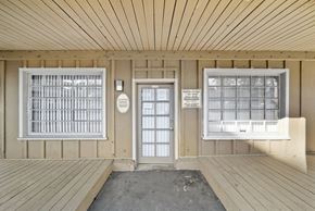 Santa Ana apartment for rent - A wooden porch with a door and windows.