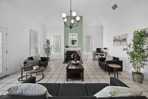 Palmdale apartment for rent - A living room with a fireplace and a chandelier.