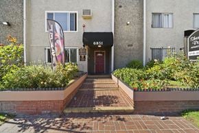 Van Nuys apartment for rent - The front of a building with a red door and a sign that says "6851".