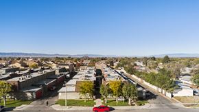 Lancaster apartment for rent - A red car is parked on the side of a road in a suburban area.