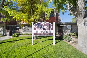 Lancaster apartment for rent - A sign for Somerset Townhomes stands in a grassy area.