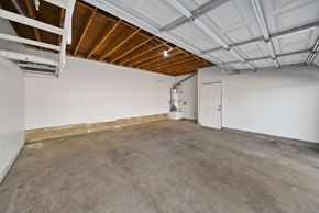 Lancaster apartment for rent - A spacious room with a concrete floor and a white door.