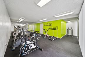 Van Nuys apartment for rent - A gym with exercise bikes and a sign that says "Be Stronger Than Your Excuses".