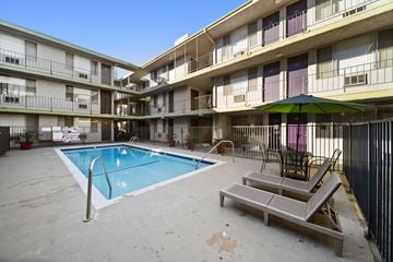 Van Nuys apartment for rent - A pool in a courtyard surrounded by apartment buildings.