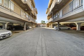 Los Angeles apartment for rent - A parking lot with cars parked on both sides of the road.