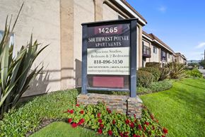 Arleta apartment for rent - A sign for Southwest Pointe Apartments is displayed in front of a building.