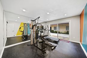 Arleta apartment for rent - A gym with a treadmill, weights, and other exercise equipment.