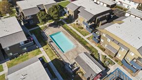 Rialto apartment for rent - A swimming pool is surrounded by houses.