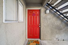 San Bernardino apartment for rent - A red door with a welcome mat in front of it.