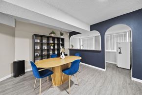 North Hollywood apartment for rent - A dining area with a round table and blue chairs.