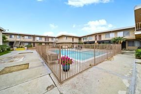 North Hollywood apartment for rent - A pool surrounded by a fence with a flower pot on it.