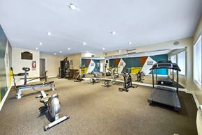 North Hollywood apartment for rent - A gym with a variety of exercise equipment including treadmills, stationary bikes, and weight machines.