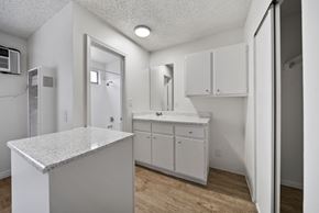 North Hollywood apartment for rent - A white kitchen with a granite counter top and white cabinets.