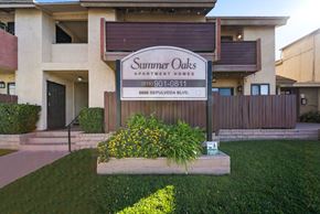 Van Nuys apartment for rent - A sign for Summer Oaks Apartment Homes is displayed in front of a building.