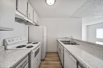 Van Nuys apartment for rent - A kitchen with white appliances and cabinets.