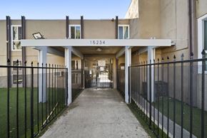 North Hills apartment for rent - A long concrete walkway leads to a building with the number 15234 on it.