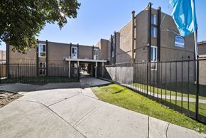 North Hills apartment for rent - A building with a blue flag in front of it.