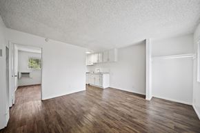 Long Beach apartment for rent - A large empty room with wooden floors and white walls.
