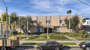 Reseda apartment for rent - A beige building with a black car parked in front of it.
