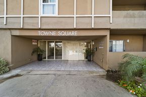 Panorama City apartment for rent - Towne Square building entrance with a sign above the door.