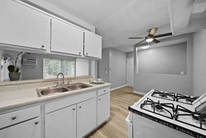 North Hollywood apartment for rent - A kitchen with white cabinets and a stove top oven.