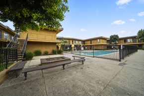North Hollywood apartment for rent - A pool and patio area of a building with benches.