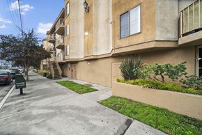 North Hollywood apartment for rent - A building with a green lawn in front.