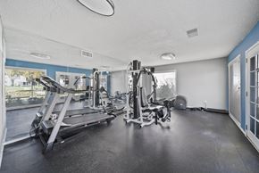 Palmdale apartment for rent - A spacious gym with treadmills, elliptical machines, and other exercise equipment.