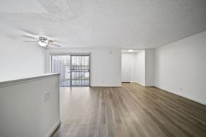 San Bernardino apartment for rent - A room with a ceiling fan and a wooden floor.