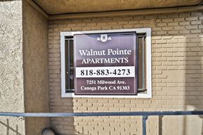 Canoga Park apartment for rent - A sign for Walnut Pointe Apartments is on a building.