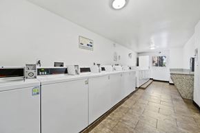 Los Angeles apartment for rent - A row of washing machines are lined up in a laundromat.