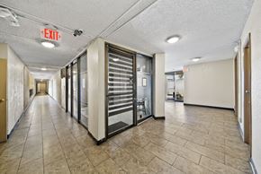 Los Angeles apartment for rent - A long hallway with a red exit sign on the ceiling.