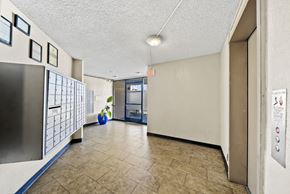 Los Angeles apartment for rent - A hallway with a blue vase and a fridge on the left.